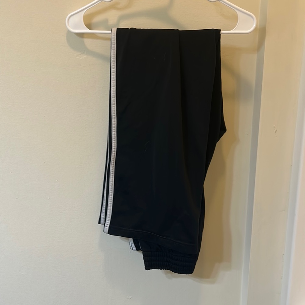 Black adidas pants with white triple stripe